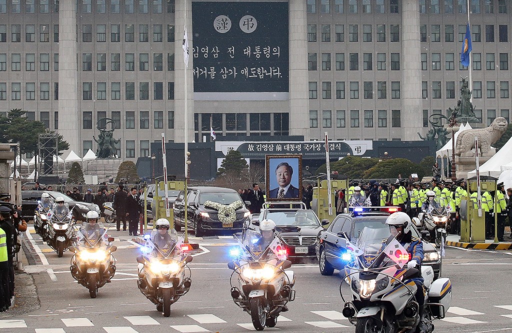 A vehicle putting up a portrait of the late former South Korean President Kim Young-sam leads a hearse after the state funeral for Kim at the National Assembly in Seoul, South Korea, Thursday, Nov. 26, 2015. Thousands of mourners gathered at the lawn outside parliament Thursday to say their farewells to Kim, whose landmark 1992 election victory ended decades of military rule and ushered in a series of reform measures. (AP Photo/Ahn Young-joon. Pool) 