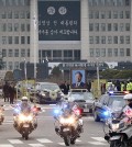 A vehicle putting up a portrait of the late former South Korean President Kim Young-sam leads a hearse after the state funeral for Kim at the National Assembly in Seoul, South Korea, Thursday, Nov. 26, 2015. Thousands of mourners gathered at the lawn outside parliament Thursday to say their farewells to Kim, whose landmark 1992 election victory ended decades of military rule and ushered in a series of reform measures. (AP Photo/Ahn Young-joon. Pool)