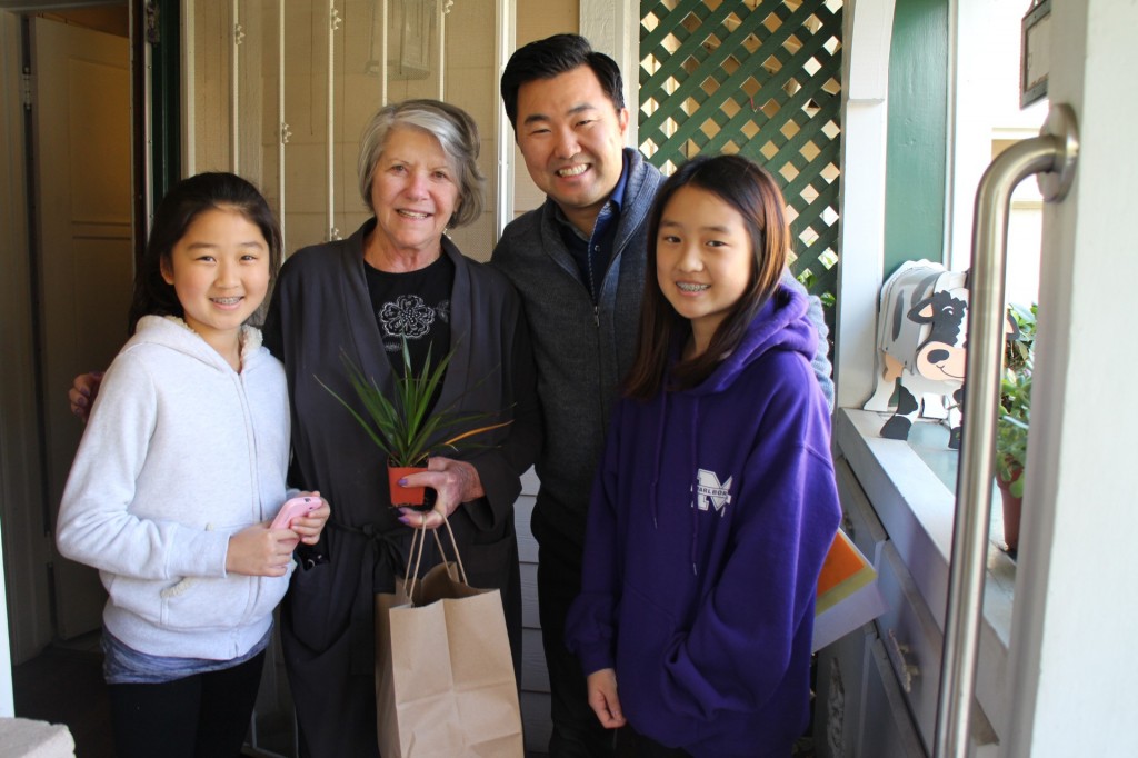 Los Angeles City Councilman David Ryu, second from right, delivers a Meals on Wheels Thanksgiving meal to a local senior with volunteers Thursday.