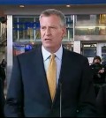 In this photo provided by WNYW Fox 5 NY, New York Mayor Bill de Blasio speaks during a news conference in New York's Times Square, Wednesday, Nov. 18, 2015. The New York Police Department says it's aware of a newly released Islamic State group video showing images of Times Square but says there's no current or specific threat to the city. (WNYW Fox 5 NY via AP)