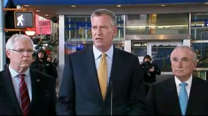 In this photo provided by WNYW Fox 5 NY, New York Mayor Bill de Blasio speaks during a news conference in New York's Times Square, Wednesday, Nov. 18, 2015. The New York Police Department says it's aware of a newly released Islamic State group video showing images of Times Square but says there's no current or specific threat to the city. (WNYW Fox 5 NY via AP)