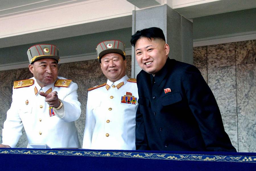 In this Sunday, April 15, 2012 photo released by the Korean Central News Agency and distributed by the Korea News Service on April 16, 2012, North Korean leader Kim Jong-un, right, smiles with the Korean People's Army senior officers, Vice Marshal and Vice Chairman of the Central Military Commission Choe Ryong-hae, center, and Vice Marshal and the military's General Staff Chief Ri Yong-ho, during a mass military parade in Kim Il Sung Square to celebrate the centenary of the birth of his grandfather, national founder Kim Il-sung in Pyongyang, North Korea. (Yonhap/KCNA)