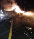 The wreckage of a U.S. military AH-64 Apache helicopter is burning along a road in Wonju, South Korea, Monday, Nov. 23, 2015. A U.S. military helicopter crashed in South Korea on Monday, killing two people on board, police said. (Park Young-suh/Yonhap)