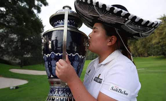 Inbee Park kisses the championship trophy after winning the Lorena Ochoa Invitational in Mexico. (AP) 