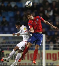 South Korea's Koo Ja-cheol, right, fights for the ball with Myanmar's Kyaw Ko Ko during their Asian zone Group G qualifying soccer match for the 2018 FIFA World Cup at Suwon World Cup Stadium in Suwon, South Korea, Thursday, Nov. 12, 2015. South Korea defeated Myanmar 4-0. (AP Photo/Lee Jin-man)