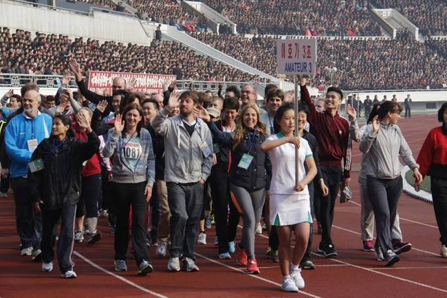Foreign runners join a ceremony to mark the annual Pyongyang Marathon in this photo taken in August 2014. North Korea plans to invite up to 1,500 marathoners from abroad in April next year.  (Courtesy of Koryo Tours)