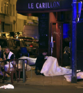Victims lay on the pavement outside a Paris restaurant, Friday, Nov. 13, 2015. Police officials in France on Friday report multiple terror incidents, leaving many dead. It was unclear at this stage if the events are linked. (AP Photo/Thibault Camus)