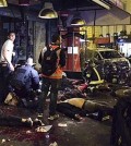 Victims of a shooting attack lay on the pavement outside La Belle Equipe restaurant in Paris Friday, Nov. 13, 2015. Well over 100 people were killed in Paris on Friday night in a series of shooting, explosions. (Anne Sophie Chaisemartin via AP)