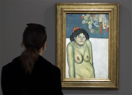 FILE - This Oct. 30, 2015 file photo shows "The Nightclub Singer,” a 1901 painting by Picasso from his Blue Period, at Sotheby's in New York. The work features a second picture on the reverse side depicting Picasso’s art dealer, Pere Manach. The piece is estimated to fetch $60 million on Thursday night, Nov. 5, 2015 at Sotheby’s fall art auction. (AP Photo/Richard Drew, File)