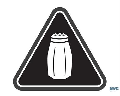 File-In this undated image released by the New York City Health Department, shows a graphic that will soon be warning NYC consumers of high salt content. New York City is opening a new era in nutritional warnings this week: Chain restaurants will have to start putting a special symbol on highly salty dishes. The first-of-its-kind rule takes effect Tuesday. It will require a salt-shaker-like emblem on some sandwiches, salads and other menu items that top the recommended daily limit of 2,300 milligrams of sodium. That’s about a teaspoon. (Antonio D'Angelo/New York City Health Department via AP)