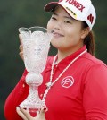 Sun-ju Ahn of South Korea smiles with a trophy after winning the Toto Japan Classic, her first LPGA Tour victory, in Shima, central Japan. Ahn won the 20th Japan LPGA title, beating fellow South Korean player Ji-Hee Lee and American Angela Stanford with a birdie on the first hole of a playoff. (Naoya Osato/Kyodo News via AP)