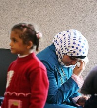 A woman who identified herself as a Syrian refugee shows tears while waiting at the immigration office of Incheon International Airport, west of Seoul, with people who appear to be her family, Wednesday. National Intelligence Service reported to the National Assembly on the day that 200 Syrian refugees have entered the country so far, and 135 of them were granted temporary stay permits until the justice ministry determines whether to accept them. The agency said 48 foreigners have been deported since 2010 for their affiliation with terrorist groups. (Yonhap)