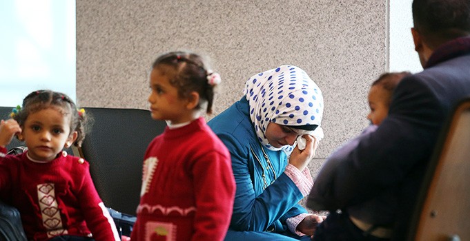 A woman who identified herself as a Syrian refugee shows tears while waiting at the immigration office of Incheon International Airport, west of Seoul, with people who appear to be her family, Wednesday. National Intelligence Service reported to the National Assembly on the day that 200 Syrian refugees have entered the country so far, and 135 of them were granted temporary stay permits until the justice ministry determines whether to accept them. The agency said 48 foreigners have been deported since 2010 for their affiliation with terrorist groups. (Yonhap)
