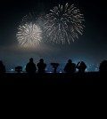 People watch and use their smartphones to take picture of fireworks, to celebrate the New Year at the Imjingak Pavilion near the border village of Panmunjom in Paju, South Korea, Friday, Jan. 1, 2016. (AP Photo/Lee Jin-man)