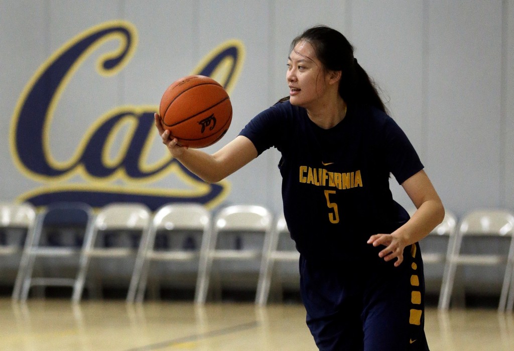In this Dec. 12, 2015 photo, California's Chen Yue rebounds during a team workout in Berkeley, Calif. The 6-foot-7 freshman center, who is believed to be one of the first Chinese basketball players to play at a high college level, says she came to the U.S. to challenge herself both on the court and in the classroom. (AP Photo/Ben Margot)