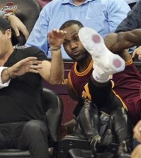 Cleveland Cavaliers' LeBron James falls into Ellie Day, wife of PGA Tour golf player Jason Day, at left, during the second half of an NBA basketball game against the Oklahoma City Thunder, Thursday, Dec. 17, 2015, in Cleveland. (John Kuntz/The Plain Dealer via AP)