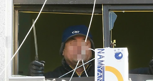 A man in his 60s is seen holing a knife inside