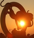 The sun rises over a sculpture of baby monkeys on Ganjeol Cape, a coastal point where a sunrise can be viewed earliest on the Korean Peninsula, on the coast of Ulsan in southeastern South Korea on Jan. 1, 2016, as visitors gather around the monument to view the New Year's first sunrise and make their New Year's wishes. The monument was set up to celebrate the new year, which falls on the year of the monkey in the Oriental zodiac. (Yonhap)
