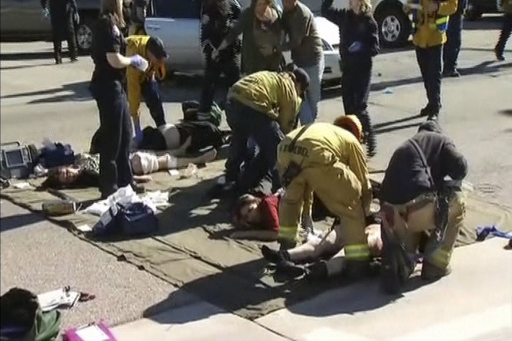 Rescue crews tend to the injured in the intersection outside the Inland Regional Center in San Bernardino, California in this still image taken from video December 2, 2015. At least 20 people were reported injured in an active shooter situation, according to news reports. (Reuters/NBCLA.com/Yonhap)