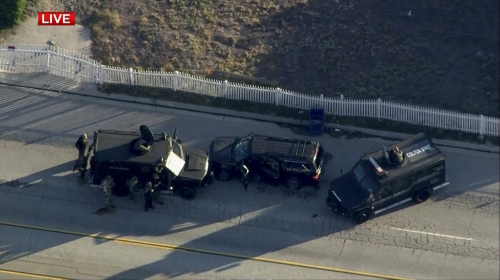 Police armored cars close in on a suspect vehicle following a shooting incident in San Bernardino, California in this still image taken from video December 2, 2015. Gunmen opened fire on a holiday party on Wednesday at a social services agency in San Bernardino, killing 14 people and wounding 17 others before fleeing, authorities said. (Reuters/NBCLA.com via Yonhap)