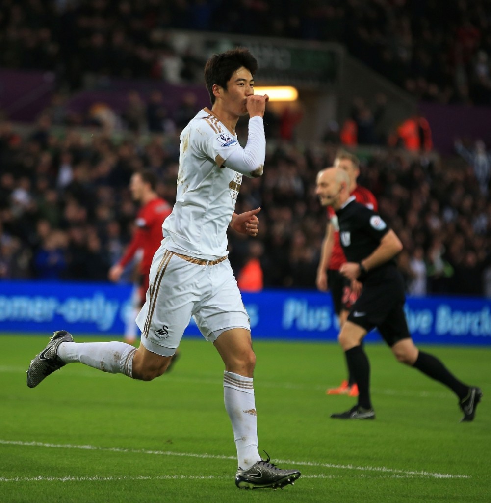 Swansea City's Ki Sung-yueng celebrates scoring the opening goal against West Bromwich Albion during the English Premier League soccer match at the Liberty Stadium, Swansea, Wales, Saturday Dec. 26, 2015. (Nick Potts/PA via AP)