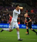 Swansea City's Ki Sung-yueng celebrates scoring the opening goal against West Bromwich Albion during the English Premier League soccer match at the Liberty Stadium, Swansea, Wales, Saturday Dec. 26, 2015. (Nick Potts/PA via AP)