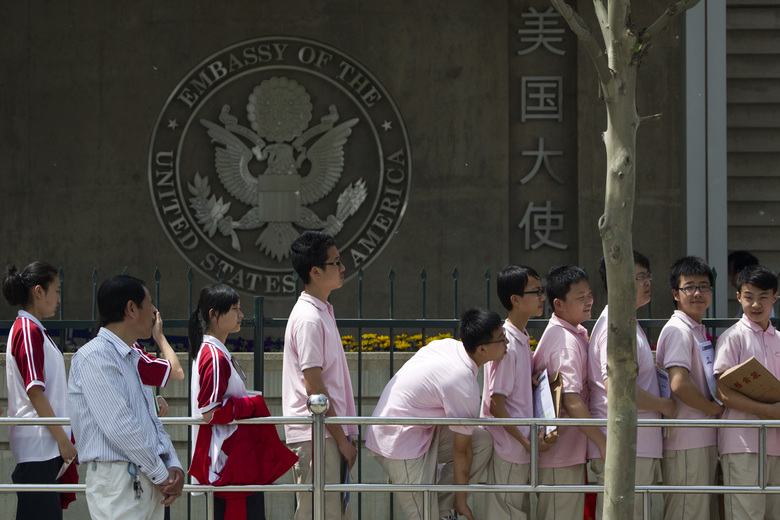FILE -- In this May 2012 file photo, Chinese students wait outside the U.S. Embassy for their visa application interviews in Beijing, China.  The number of international students studying at U.S. colleges increased by 10 percent last year, marking the largest single-year gain in 35 years, according to new federal data. (AP Photo/Alexander F. Yuan, File)