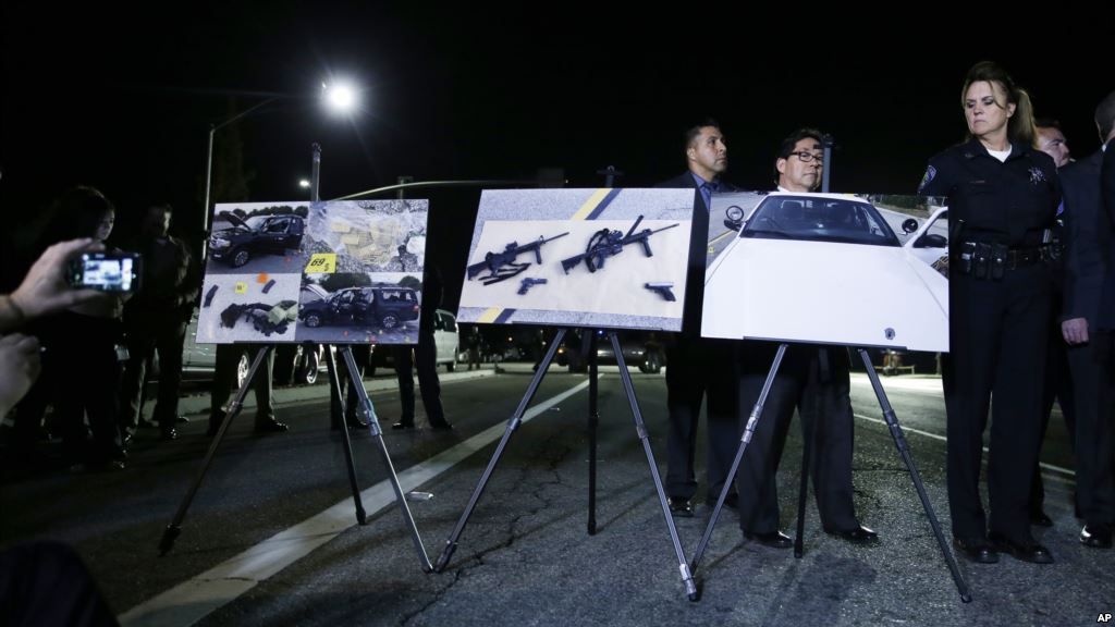 Police crime photos are displayed during a news conference near the site of yesterday's mass shooting on Thursday, Dec. 3, 2015 in San Bernardino, Calif. A husband and wife on Wednesday, dressed for battle and carrying assault rifles and handguns, opened fire on a holiday banquet for his co-workers, killing at least 14 people and seriously wounding more than a dozen others in a precision assault, authorities said. Hours later, the couple died in a shootout with police. (AP Photo/Chris Carlson)