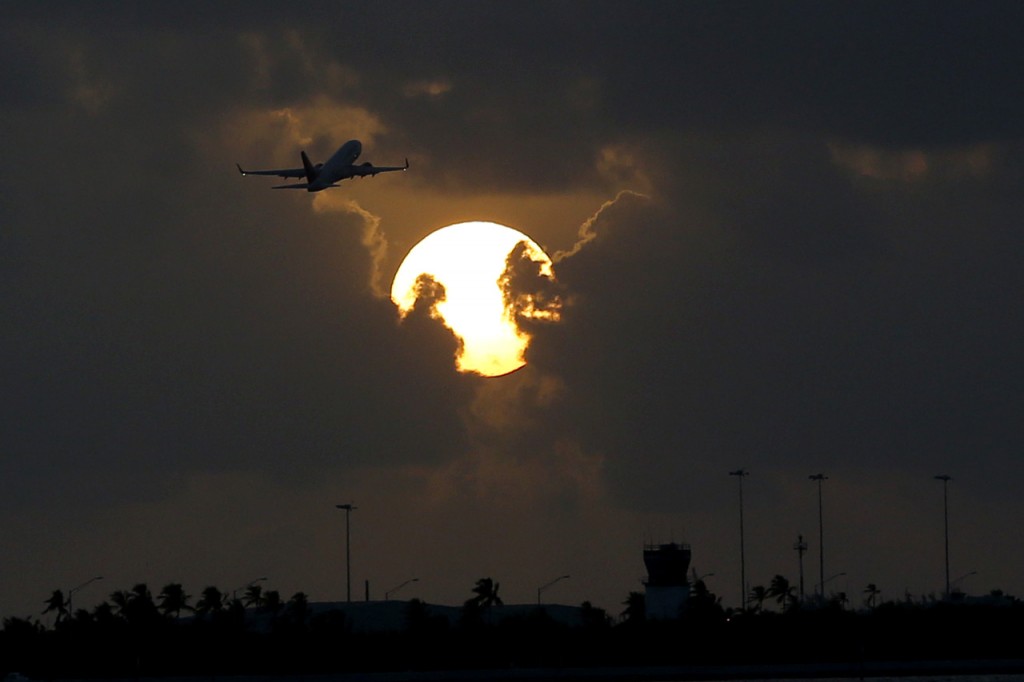 A plane takes off from Key West International Airport as the sun rises, Thursday, Aug. 6, 2015, in Key West, Fla. (AP Photo/Julio Cortez)