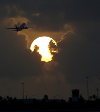 A plane takes off from Key West International Airport as the sun rises, Thursday, Aug. 6, 2015, in Key West, Fla. (AP Photo/Julio Cortez)