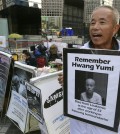 In this Oct. 23, 2015 photo, Hwang Sang-gi, a founding member of advocacy group Banolim, holds a picture of his daughter Yu-mi during an interview denouncing Samsung’s response in its latest negotiations with sick workers outside Samsung buildings in Seoul, South Korea. Yu-mi’s death from leukemia in 2007 galvanized concern about conditions at Samsung factories and South Korea’s semiconductor industry in general. Samsung’s hopes of ending years of acrimony and bad publicity over whether its semiconductor factories caused cancer have hit a hitch: some sickened workers and their families say they’ll never accept its highly conditional offer of financial assistance. (AP Photo/Ahn Young-joon)