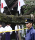 A police officer stands guard Yasukuni Shrine in Tokyo following an explosion in its public restroom. Police in Tokyo have arrested a South Korean man suspected of causing an explosion last month at the controversial shrine in Tokyo that honors Japanese war dead. The 27-year-old Jeon Chang-han was arrested Wednesday, Dec. 9 after he returned to Tokyo from South Korea for voluntary questioning, police officials said. (AP Photo/Koji Sasahara)