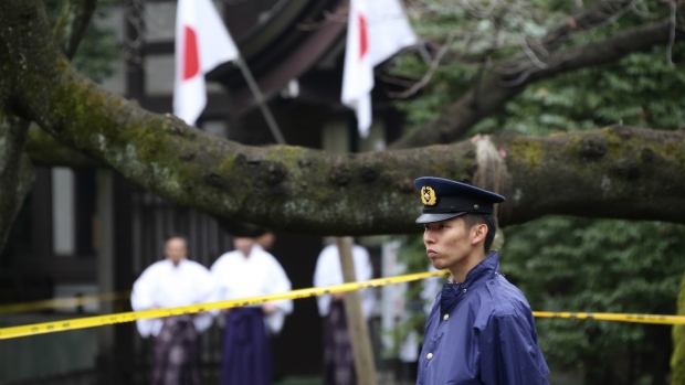 A police officer stands guard Yasukuni Shrine in Tokyo following an explosion in its public restroom. Police in Tokyo have arrested a South Korean man suspected of causing an explosion last month at the controversial shrine in Tokyo that honors Japanese war dead. The 27-year-old Jeon Chang-han was arrested Wednesday, Dec. 9 after he returned to Tokyo from South Korea for voluntary questioning, police officials said. (AP Photo/Koji Sasahara)