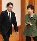 Japanese Foreign Minister Fumio Kishida, left, is shown the way by South Korean President Park Geun-hye prior to a meeting at the presidential house in Seoul, South Korea, Monday, Dec. 28, 2015. The foreign ministers of South Korea and Japan said Monday they had reached a deal meant to resolve a decades-long impasse over Korean women forced into Japanese military-run brothels during World War II, a potentially dramatic breakthrough between the Northeast Asian neighbors and rivals. (Chun Jean-hwan/Newsis via AP)