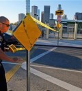 A police officer puts up yellow tape to close the school outside of Edward Roybal High School in Los Angeles, on Tuesday morning, Dec. 15, 2015. All schools in the vast Los Angeles Unified School District, the nation's second largest, have been ordered closed due to an electronic threat Tuesday. (AP Photo/Richard Vogel)