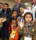 Refugees from Myanmar wave to reporters as they arrive at Incheon International Airport on Dec. 22, 2015 for resettlement. (Yonhap)