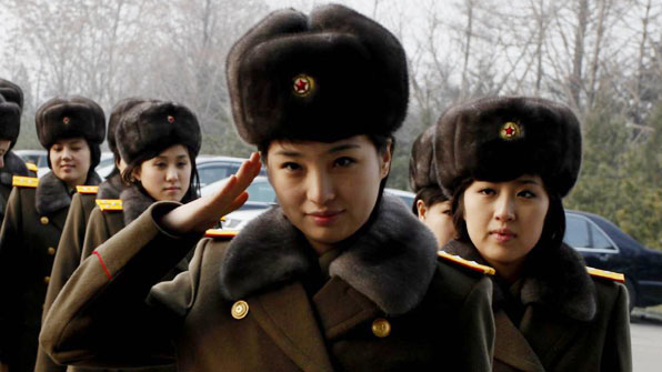 Members of the Moranbong Band and the State Merited Chorus of North Korea walk to get on a train at the station in Pyongyang, North Korea, Wednesday, Dec. 9, 2015. They give friendship performances in China. (AP Photo/Kim Kwang Hyon)