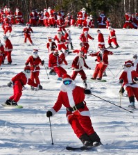 Skiers and snowboarders dressed as Santa take a run en masse at the Sunday River ski resort, Sunday, Dec. 6, 2015, in Newry, Maine. Skiers with full Santa outfits got free lift tickets for donating $15 to the Sunday River Community Fund. (AP Photo/Robert F. Bukaty)