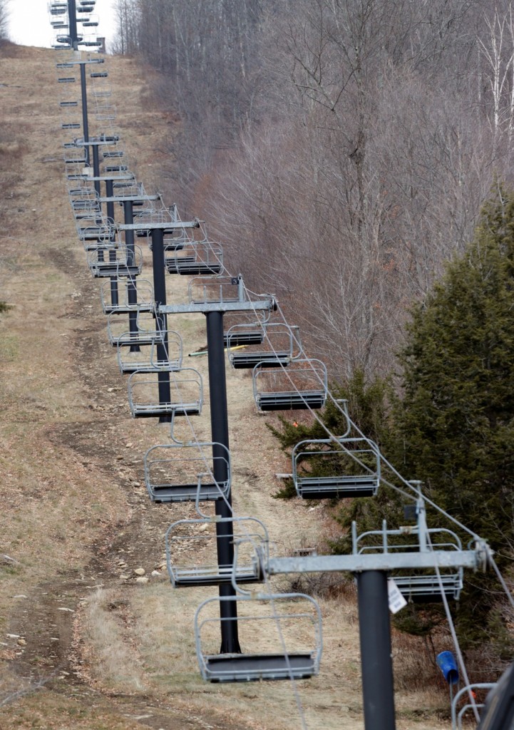 A chairlift sits idle at Oak Mountain Ski Center on Tuesday, Dec. 8, 2015, in Speculator, N.Y. Some Northeasterners are beginning to wonder if a white Christmas may just be a dream, and business owners who rely on snow are starting to worry if warm weather could lead to a nightmare winter. (AP Photo/Mike Groll)