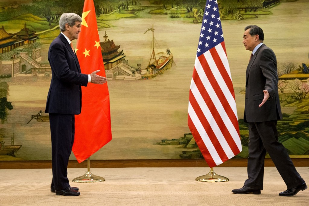 U.S. Secretary of State John Kerry, left, and Chinese Foreign Minister Wang Yi approach to shake hands after attending a news conference at the Ministry of Foreign Affairs in Beijing, Wednesday, Jan. 27, 2016. Kerry is on the final leg in his latest round-the-world diplomatic mission. (AP Photo/Jacquelyn Martin, Pool)