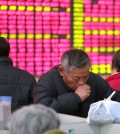 A Chinese stock investor monitors stock prices at a brokerage house in Nantong in eastern China's Jiangsu province Wednesday, Jan. 6, 2016. China plans to restrict stock sales by large shareholders once a ban imposed in July to stop a slide in prices is lifted this week. (Chinatopix via AP)