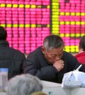 A Chinese stock investor monitors stock prices at a brokerage house in Nantong in eastern China's Jiangsu province Wednesday, Jan. 6, 2016. China plans to restrict stock sales by large shareholders once a ban imposed in July to stop a slide in prices is lifted this week. (Chinatopix via AP)