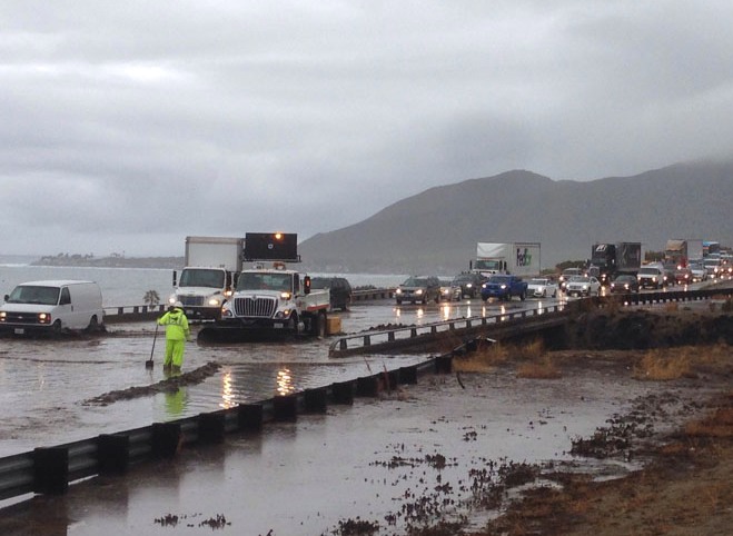 Portions of the 101 freeway in Ventura flood due to rain on Tuesday, Jan. 5, 2016, in Ventura, Calif. Persistent wet conditions could put some Los Angeles County communities at risk of flash flooding along with mud and debris flows, especially in wildfire burn areas. El Nino storms lined up in the Pacific, promising to drench parts of the West for more than two weeks and increasing fears of mudslides and flash floods in regions stripped bare by wildfires. (Juan Carlo/Ventura County Star via AP)