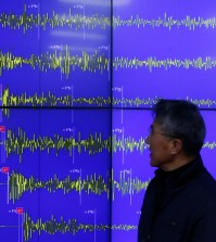 Earthquake and Volcano of the Korea Meteorological Administration Director General Yun Won-tae stands in front of a screen showing seismic waves that were measured in South Korea, in Seoul Wednesday, Jan. 6, 2016. North Korea said it conducted a powerful hydrogen bomb test Wednesday, a defiant and surprising move that, if confirmed, would be a huge jump in Pyongyang's quest to improve its still-limited nuclear arsenal. (AP Photo/Lee Jin-man)