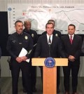 Los Angeles Mayor Eric Garcetti, center at podium, and police chief Charlie Beck, center left, are among officials reporting about crime in the city at a downtown news conference Wednesday, Jan. 13, 2016. Although crimes including murder and rape are up across the board in Los Angeles, the city is still far less violent than it has been in the past, city leaders said, as they released citywide statistics for 2015. (AP Photo/Amanda Myers)