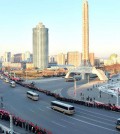 Buses carrying nuclear scientists, military officials and construction workers line a street in Pyongyang while residents cheer after North Korea conducted a fourth nuclear test on Jan. 6. Up to 100,000 citizens were mobilized for the event. North Korea's Rodong Sinmun newspaper published the photograph on Thursday. (Yonhap)