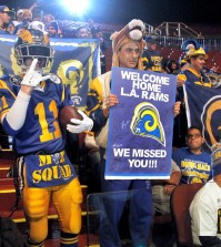 Rams fans cheer for the NFL football team at a news conference at the Forum in Inglewood, Calif., on Friday, Jan. 15, 2016. The St. Louis Rams are returning to play in 2016 in the Los Angeles area; in a few years the team will begin play at a stadium being built near the Forum. (AP Photo/Nick Ut)