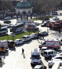 Ambulances and firefighters stationed near the city's landmark Sultan Ahmed Mosque or Blue Mosque after an explosion at Istanbul's historic Sultanahmet district, which is popular with tourists, Tuesday, Jan. 12, 2016. The Istanbul governor's office says the explosion at the city's historic Sultanahmet district has killed least 10 people. A statement says 15 other people were injured in Tuesday's blast. The cause of the explosion is under investigation, but state-run TRT television says it was likely caused by a suicide bomber. The monument in the background is "German Fountain." (IHA via AP) TURKEY OUT
