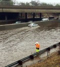 In this photo provided by the California Department of Transportation, a Caltrans worker probes for a drain in standing water that closed down most lanes of both sides of Interstate 5, the Golden State Freeway, in the Sun Valley area of Los Angeles' San Fernando Valley Wednesday, Jan. 6, 2016. El Nino storms left several inches of rain and snow throughout California, with more precipitation expected later in the week.(Jeremy Theisgen/California Department of Transportation via AP)
