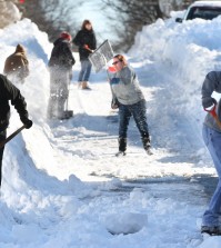 Residents of W. Leicester St. in Winchester, Va. join forces to shovel out on Sunday, Jan. 24, 2016, after an historic snowstorm dumped more than 30 inches of snow on the city Friday night and Saturday. (Jeff Taylor/The Winchester Star via AP)